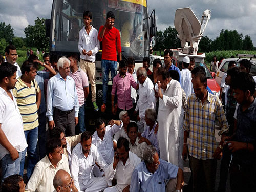 People block national highway 91 in Bulandshahr against rape of a woman and her 13-year-old girl, on Sunday. PTI Photo