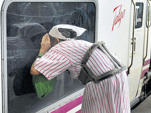 A woman looks through the window of the Talgo train in Mumbai on Tuesday. PTI