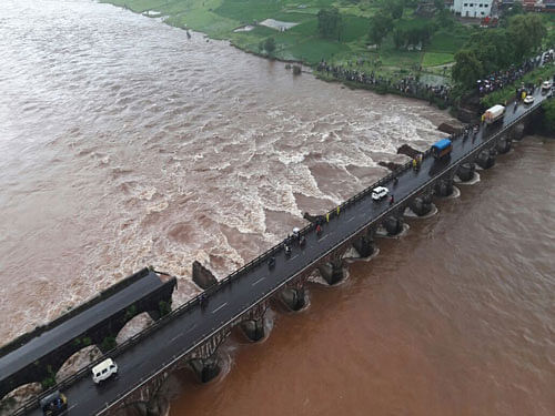 At least two persons drowned and 20 others are missing after a British-era bridge collapsed on the Mumbai-Goa Highway near Mahad in Maharashtra's Raigad district. Image courtesy Twitter.