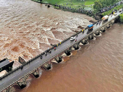 An aerial view of the Mahad-Poladpur bridge that was washed away in floodwater, on the Mumbai-Goa highway in the Raigad district of Maharashtra  on Wednesday. DH&#8200;photo