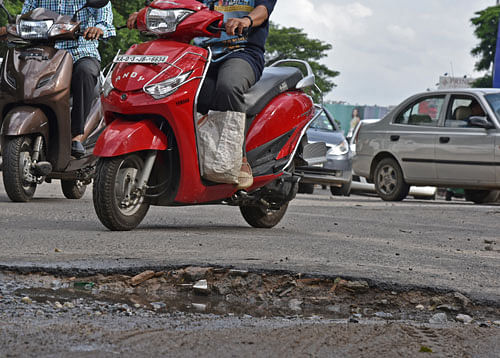 Risky ride: A crater on Berlie Street Road and Hosur Road junction.