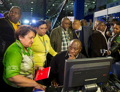 Deputy President Cyril Ramaphosa, seated, and African National Congress party members discuss municipal election results at the results center in Pretoria, South Africa, Friday, Aug. 5, 2016. With 95 percent of votes counted the ruling ANC appears to have suffered its biggest electoral blow since it won power at the end of the apartheid era 22 years ago. AP/PTI