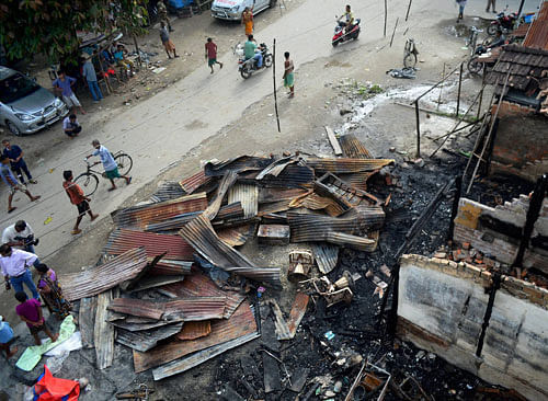 Debris of burnt shops after they were destructed in terrorist attack at Balijan Tanali market in Kokrajhar district of Assam on Saturday. PTI Photo