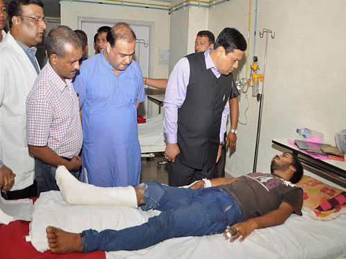 Assam Chief Minister Sarbananda Sonowal visits Gauhati Medical College where injured in terrorist attack at Balajan Tiniali market are admitted in Kokrajhar on Saturday. PTI Photo