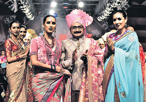 grand Ashok R Maanay with models displaying his collection.