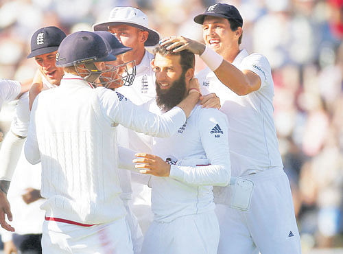 Dominant: Moeen Ali (centre) celebrates England's win with team-mates on Sunday. REUTERS