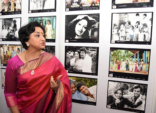 Veteran actor Lakshmi reminisces her Kannada celluloid journey as she looks at stills at  an exhibition organised as part of the 'Belli Hejje' series in the city on Sunday. DH photo