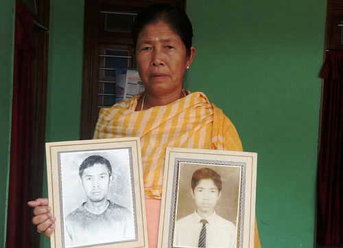 Siman Ongbi Chandrajini with the photographs of her two sons who were among the 10 victims of Malom massacre. Deepak Oinam