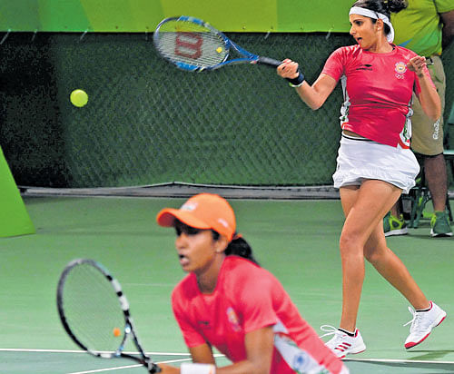 opening blues: India's Sania Mirza returns as partner Prarthana Thombare looks on during their opening round  defeat to China's Peng Zhuai and Zhang Zhuai in Rio on Saturday. dh photo/ kn shanth kumar