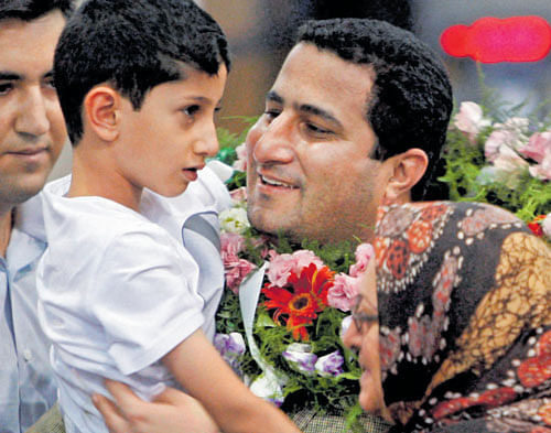 shrouded in mystery: In this July 2010 file photo, Shahram Amiri, an Iranian nuclear scientist, greets his son Amir Hossein as he arrives at the Imam Khomeini airport in Tehran from the US. Amiri, who was caught up in a real-life US spy mystery, was reportedly hanged this week and family members held a memorial service for him.  AP/PTI