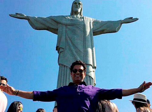 Sachin Tendulkar strikes a pose in front of Christ the Redeemer statue in Rio de Janerio on Saturday. PTI Photo