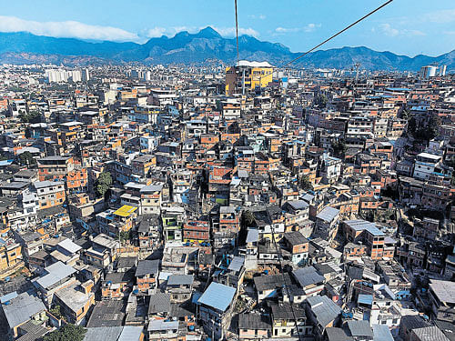 squalor next door: The Complexo do Alemao, a sprawling patchwork of slums in Rio de Janeiro. In Rio's slums, gang wars and police raids provide a stark contrast to the excitement of the Games happening just across the city. nyt