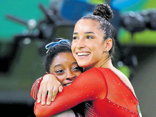 well deserved: Alexandra Raisman and silver medalist of the US congratulates her  team-mate and gold medalist Simone Biles (right) at the  Rio Olympic Centre on Thursday. AFP