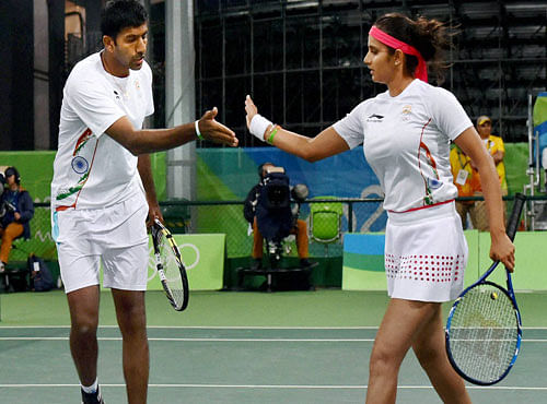 Sania Mirza and Rohan Bopanna exchange hifi during their match against S. Stosur and J. Peers of Australia during the 2016 Summer Olympics at Rio de Janeiro in Brazil on Thursday . PTI