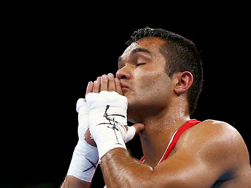 Vikas Krishan (IND) of India reacts after winning his bout. Reuters Photo.