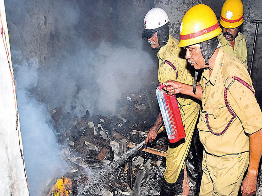 Fire and Emergency Services personnel trying to douse fire at a house at Mandi Mohalla in Mysuru on Saturday. DH photo