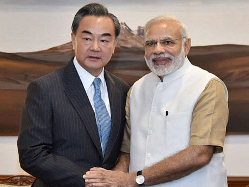 Chinese Foreign Minister Wang Yi and Prime Minister Narendra Modi in New Delhi on Saturday. PTI