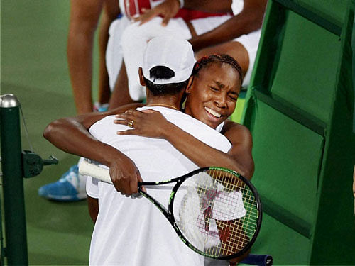Venus Williams and Rajeev Ram of USA celebrate after beating Sania Mirza and Rohan Bopanna of India in the mixed-doubles semifinal match at the 2016 Summer Olympics in Rio de Janerio, Brazil on Satuday. PTI Photo.