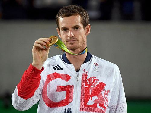 Gold medalist Andy Murray (GBR) of Britain reacts after receiving his medal. REUTERS