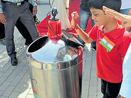 A child with the smart mobile robotic trash can