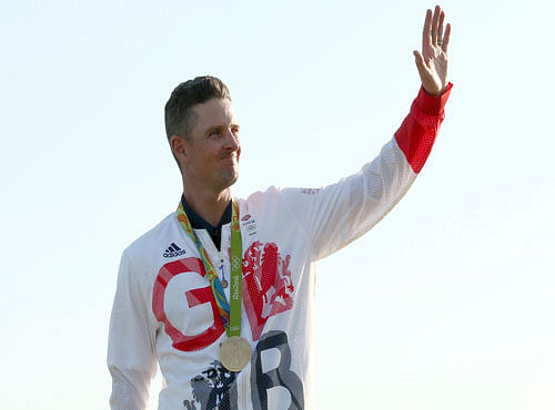 Golf - Final - Men's Individual Stroke Play - Olympic Golf Course - Rio de Janeiro, Brazil - 14/08/2016. Justin Rose (GBR) of Britain celebrates his gold medal win in the men's Olympic golf compeititon. REUTERS