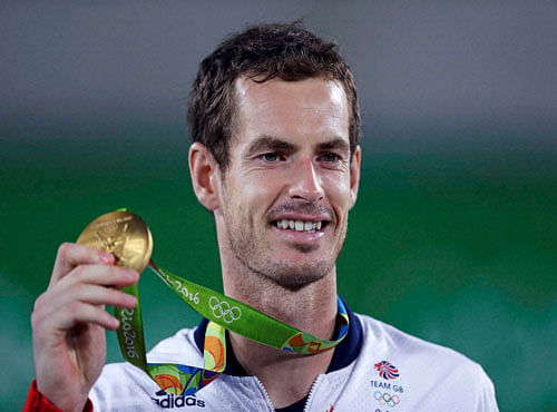 Andy Murray, of England, smiles as he holds up his gold medal at the 2016 Summer Olympics in Rio de Janeiro, Brazil, Sunday, Aug. 14, 2016. AP/PTI