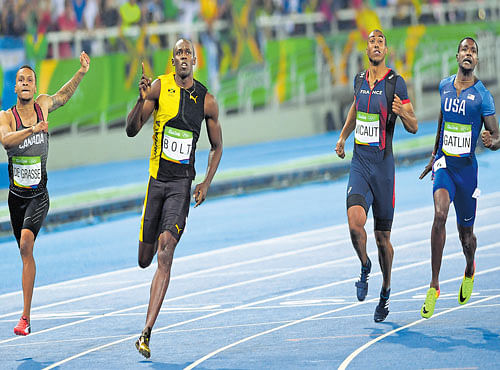 UNSTOPPABLE: Usain Bolt (second from left) of Jamaica races to 100M gold ahead of the second-placed Justin Gatlin (right) of the US and Canada's (left) Andre de Grasse in Rio de Janeiro on Sunday. DH PHOTO
