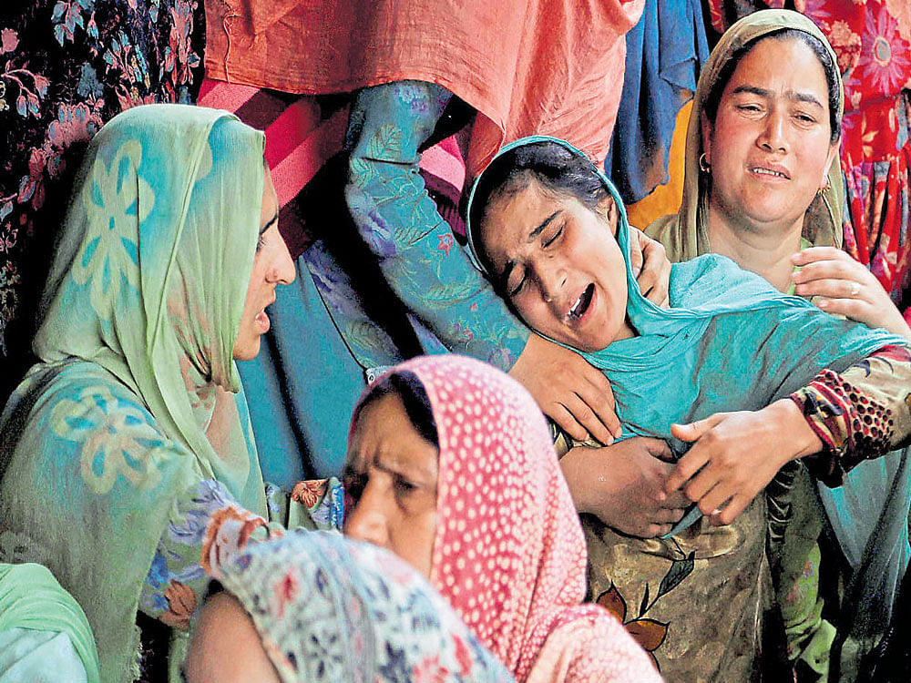 A family member of a killed civilian grieves during a joint funeral of four civilians at Aripanthan village after clashes in Srinagar on Tuesday. PTI