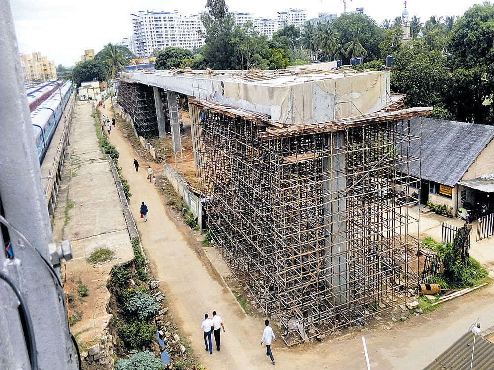 This bridge under construction will connect the Metro station with the Krantivira Sangolli Rayanna railway station. DH photo