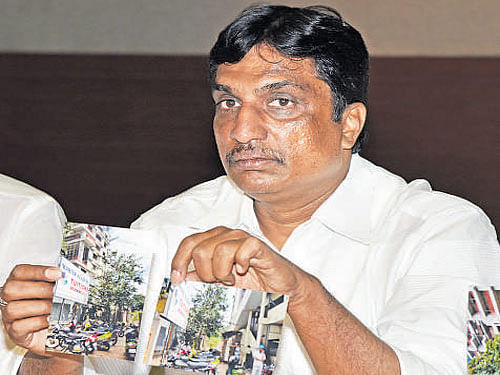 BJP leader N R Ramesh releases a list of politicians and their 'proxy' builders, who have built residential and commercial complexes on stormwater drains, at a press conference on Wednesday.
