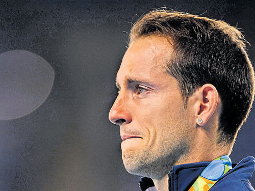 Renaud Lavillenie chokes up during medal ceremony. afp