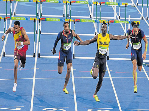 on cloud nine: Jamaica's Omar McLeod celebrates after winning the 110M hurdles gold. DH photos/ k n shanth kumar