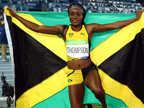 Elaine Thompson (JAM) of Jamaica celebrates after winning gold. REUTERS