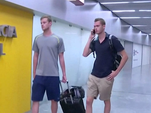 U.S. Olympic swimmers Gunnar Bentz and Jack Conger walk to the airport police station office at Rio's international airport in this still frame taken from video dated August 17, 2016, in Rio De Janeiro, Brazil . Reuters