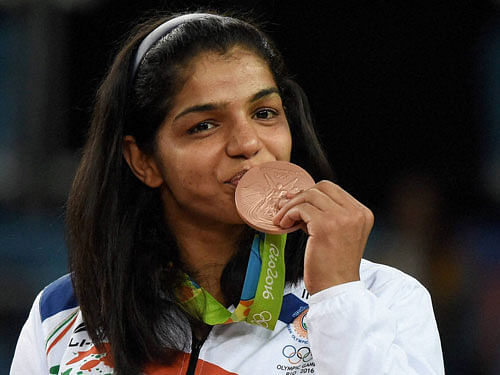 India's Sakshi Malik poses with her bronze medal for the women's wrestling freestyle 58-kg competition during the medals ceremony at the 2016 Summer Olympics in Rio de Janeiro, Brazil, Wednesday. PTI Photo