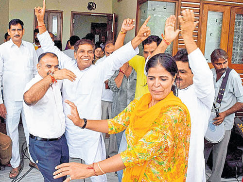 time to celebrate Sakshi's parents dance in the joy of their daughter's bronze-medal winning effort on Thursday. PTI Photo.