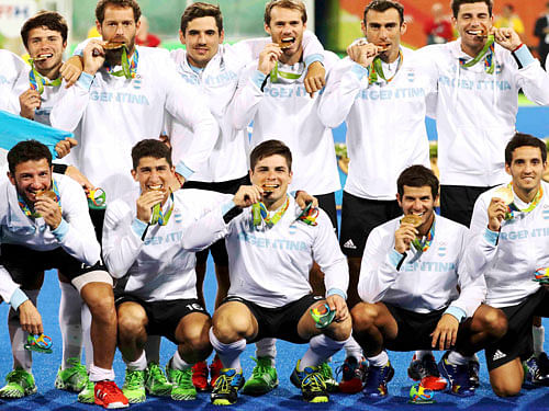 Argentina poses for photos with their gold medals. REUTERS
