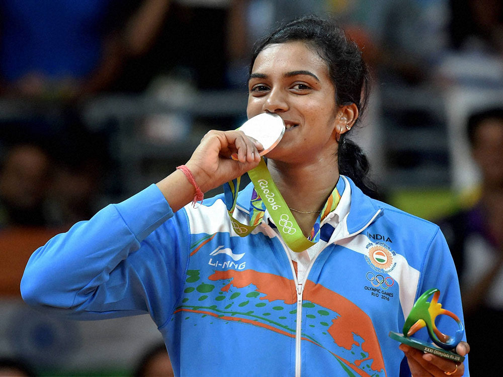 P V Sindhu kisses her silver medal after her match with Spain's Carolina Marin in women's Singles final at the 2016 Summer Olympics at Rio de Janeiro in Brazil. PTI photo