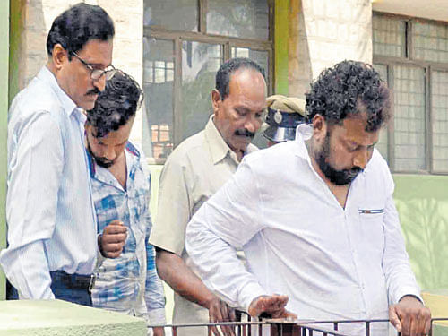 Criminal Investigation Department (CID) sleuths take Naveen Shetty and his son Ashwin to a court in Chikkamagaluru on Friday.