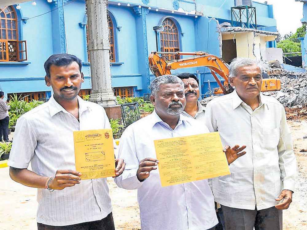 A family shows the invite of a wedding scheduled at Padmavathi Kalyana Mantapa at Rajarajeshwari Nagar in Halagevaderahalli, a part of which has been razed by the BBMP. DH photo