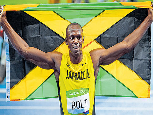 moment to cherish Usain Bolt celebrates after winning the 200 gold on Thursday. DH photo