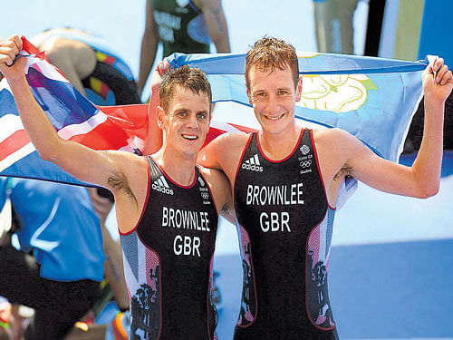 All in the family Alistair Brownlee (left) of Britain, along with his brother Jonathan, celebrates his win. AFP