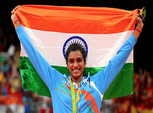 Silver medallist P.V. Sindhu poses with the Indian national flag. Reuters photo