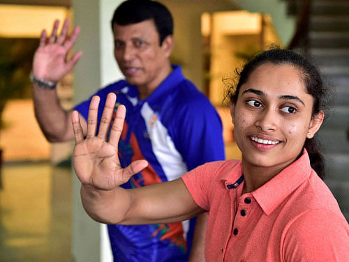 Dipa Karmakar who missed out on an Olympic medal by 0.150 points in Vaults final, with coach Bishweshwar Nandi at IG Stadium in New Delhi on Saturday. PTI Photo