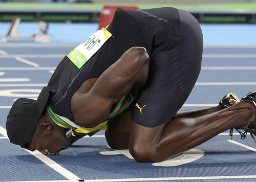 Final goodbye: Jamaica's Usain Bolt kisses the Olympic track for one last time after he anchored his team to a gold in the 4x100M relay at the Olympic stadium in Rio de Janeiro on Friday. Reuters