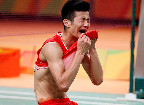 CHAMPION: China's Chen Long is overcome by emotions after winning the gold. AP/PTI