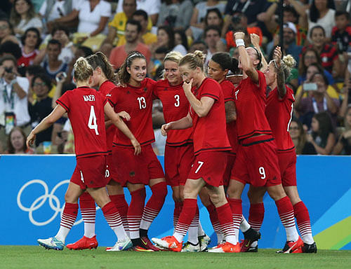 HISTORIC: The German women's team players celebrate after scoring against Sweden in the final on Friday. Germany won the match 2-0 to clinch a historic gold. REUTERS