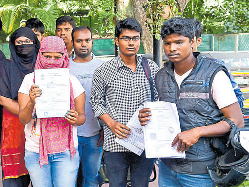 Engineering graduates hired by PC Technology Private Limited gather at Ashok Nagar police station on Saturday to complain against the firm's arbitrary closure.  DH Photo