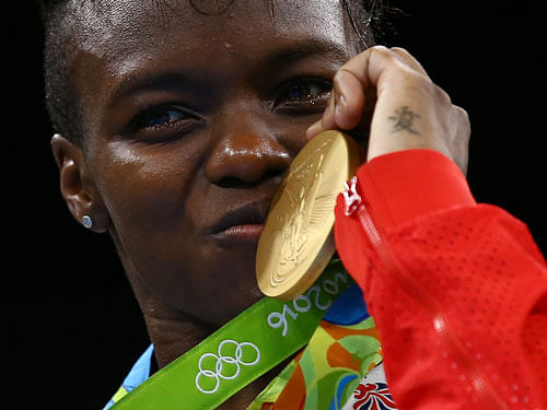 Gold medallist Nicola Adams (GBR) of Britain poses with her medal. REUTERS