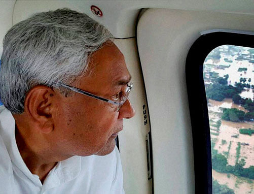 Bihar chief minister Nitish Kumar inspecting flood affected areas by a helicopter in Patna on Sunday. PTI Photo